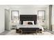 Modern bedroom with a padded headboard, bench, and decorative pillows at 215 Carova Bnd, Apex, NC 27539