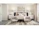 Stylized primary bedroom featuring decorative wall art and sitting area at 215 Carova Bnd, Apex, NC 27539