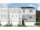 Charming new construction townhome showcasing a beautifully designed facade with a welcoming entrance and attached garage at 215 Carova Bnd, Apex, NC 27539