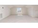 Expansive attic space bathed in natural light from a central window with neutral carpeting at 218 W Barbee Chapel Rd, Chapel Hill, NC 27517