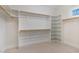 Spacious walk-in closet with built-in shelving and wooden closet rods for optimal organization at 218 W Barbee Chapel Rd, Chapel Hill, NC 27517