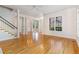 Open floor plan: hardwood floors, staircase, columns into the spacious dining room area at 218 W Barbee Chapel Rd, Chapel Hill, NC 27517
