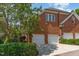 Brick home features garages, green shrubbery, and a winding drive at 218 W Barbee Chapel Rd, Chapel Hill, NC 27517