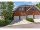 Brick home features garages, green shrubbery, and a winding drive at 218 W Barbee Chapel Rd, Chapel Hill, NC 27517