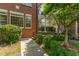 Brick townhouse exterior with manicured landscaping and charming entrance at 218 W Barbee Chapel Rd, Chapel Hill, NC 27517