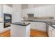 This bright eat-in kitchen offers ample storage, granite countertops, island with breakfast bar and stainless appliances at 218 W Barbee Chapel Rd, Chapel Hill, NC 27517