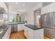 Beautiful bright kitchen featuring an island, granite countertops, stainless appliances, and an eat in breakfast bar at 218 W Barbee Chapel Rd, Chapel Hill, NC 27517