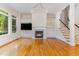 Bright living area with hardwood floors, fireplace, built-ins and staircase to the second floor at 218 W Barbee Chapel Rd, Chapel Hill, NC 27517