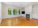 Spacious living room boasts hardwood floors, fireplace, custom built-ins and bright windows at 218 W Barbee Chapel Rd, Chapel Hill, NC 27517