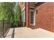 Covered patio with brick wall and railing for a clean view of the well-manicured yard at 218 W Barbee Chapel Rd, Chapel Hill, NC 27517