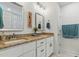 Bathroom boasts double vanity with granite countertop, mirrors, and modern fixtures at 221 Moon Cir, Dunn, NC 28334