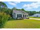 Attractive home featuring a lush lawn, inviting porch and convenient attached carport at 221 Moon Cir, Dunn, NC 28334