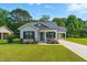 Attractive home featuring a lush lawn, inviting porch and convenient attached carport at 221 Moon Cir, Dunn, NC 28334