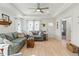 Bright living room with wood floors, a ceiling fan, and comfortable furnishings at 221 Moon Cir, Dunn, NC 28334