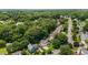 Aerial shot of a property nestled amongst verdant trees with a long driveway in a quiet neighborhood at 2216 Hoskins Rd, Burlington, NC 27215