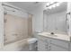 Bathroom features a tub-shower combination, toilet, vanity with storage, mirror, and marble tile flooring at 2216 Hoskins Rd, Burlington, NC 27215