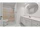 Bathroom features a tub-shower combination, toilet, vanity with storage, mirror, and marble tile flooring at 2216 Hoskins Rd, Burlington, NC 27215