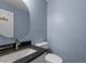 Charming powder room featuring granite countertop and a decorative mirror at 2216 Hoskins Rd, Burlington, NC 27215