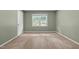 Bedroom features green walls, carpet, and a window overlooking the yard at 2216 Hoskins Rd, Burlington, NC 27215