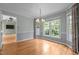 Dining room with hardwood floors, chandelier, large windows, and access to the living area at 2216 Hoskins Rd, Burlington, NC 27215