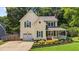 Charming two-story home featuring a covered porch, attached garage, and nicely landscaped front yard at 2216 Hoskins Rd, Burlington, NC 27215