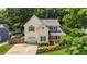 Charming two-story home featuring a covered porch, attached garage, and nicely landscaped front yard at 2216 Hoskins Rd, Burlington, NC 27215