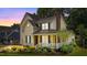 Charming two-story home featuring a brick chimney, dormer windows, and a cozy front porch with white railings at 2216 Hoskins Rd, Burlington, NC 27215
