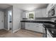 Updated kitchen with white cabinets, stainless steel appliances, and durable flooring at 2216 Hoskins Rd, Burlington, NC 27215