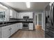 Well-appointed kitchen with stainless appliances, granite counters, and views to the dining room at 2216 Hoskins Rd, Burlington, NC 27215