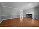 Spacious living room featuring a fireplace, wood floors, and neutral paint scheme with wainscoting at 2216 Hoskins Rd, Burlington, NC 27215