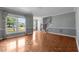 Bright living room with wood floors, large windows, and a staircase leading to the upper level at 2216 Hoskins Rd, Burlington, NC 27215