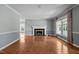 Bright and airy living room with a fireplace, wood floors, and large windows offering ample natural light at 2216 Hoskins Rd, Burlington, NC 27215