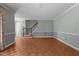 Open living room featuring wood floors, staircase, and a wainscotting design at 2216 Hoskins Rd, Burlington, NC 27215
