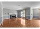 Comfortable living room showcasing a fireplace, wood floors, and natural light with adjacent rooms visible at 2216 Hoskins Rd, Burlington, NC 27215