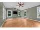 Bright living room featuring vaulted ceilings, a ceiling fan, and gleaming hardwood floors at 2216 Hoskins Rd, Burlington, NC 27215