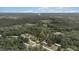 An aerial view shows the lot lines of the property in a wooded setting with nearby homes at 2396 Spring Valley Rd, Henderson, NC 27537