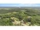An aerial view of the land and surrounding landscape, offering a glimpse of the homes in a wooded setting at 2396 Spring Valley Rd, Henderson, NC 27537