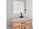 Modern bathroom with a light wood vanity, updated fixtures, and a mirror at 2396 Spring Valley Rd, Henderson, NC 27537