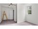 A cozy bedroom featuring neutral walls, plush carpet, and a bright window at 2396 Spring Valley Rd, Henderson, NC 27537