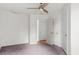 Bedroom features neutral walls, carpet, and an open door leading to another room at 2396 Spring Valley Rd, Henderson, NC 27537