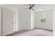 Bedroom features neutral walls, carpet, bright window, and double door closet at 2396 Spring Valley Rd, Henderson, NC 27537