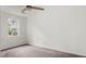 A cozy bedroom features neutral walls, plush carpet, and a bright window at 2396 Spring Valley Rd, Henderson, NC 27537