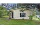 Charming exterior view of the home, surrounded by a lush green lawn and trees at 2396 Spring Valley Rd, Henderson, NC 27537
