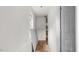 Bright hallway featuring hardwood floors and a view into the kitchen at 2396 Spring Valley Rd, Henderson, NC 27537