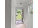 Hallway area with wood flooring, light walls, and a view of the backyard at 2396 Spring Valley Rd, Henderson, NC 27537