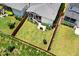 Aerial view showcasing a fenced backyard with lush lawn, neighboring homes, and mature trees at 245 Tumbling River Dr, Wendell, NC 27591