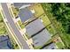 An aerial view shows rooftops of homes, manicured lawns and a street at 245 Tumbling River Dr, Wendell, NC 27591