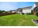 Expansive backyard with lush lawn, screened porch, and privacy fence, ideal for outdoor activities and enjoyment at 245 Tumbling River Dr, Wendell, NC 27591