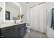 Modern bathroom with stylish vanity, sleek fixtures, and a shower tub combo with curtain at 245 Tumbling River Dr, Wendell, NC 27591