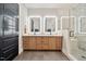 Modern bathroom with double sink vanity, backlit mirrors, decorative tiled shower, and dark tile floors at 245 Tumbling River Dr, Wendell, NC 27591